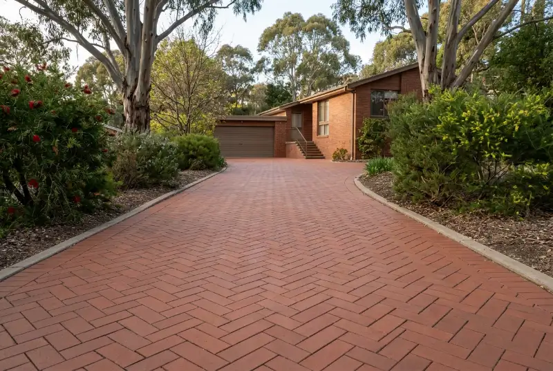 Established red clay paver driveway in herringbone in a leafy older Canberra suburb