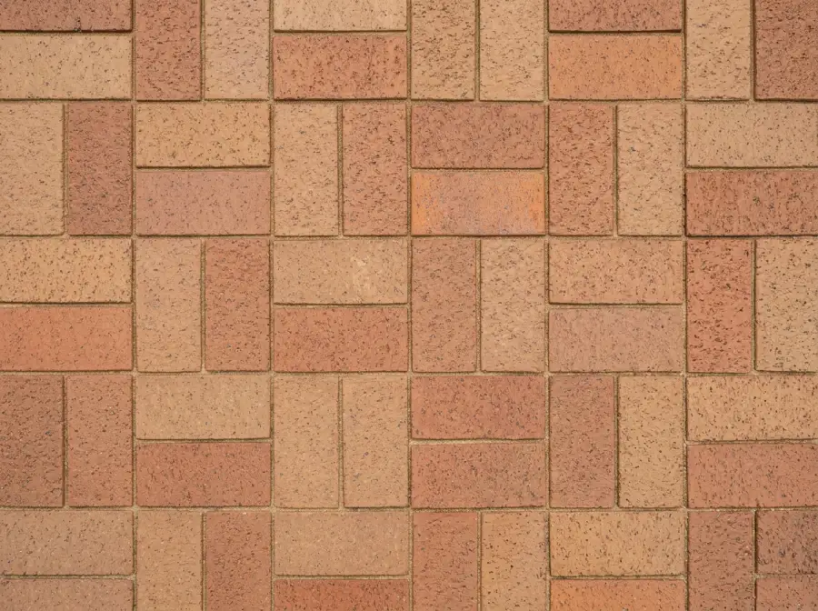 Copper and tan clay pavers laid in basket weave, seen from above